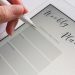 A stylus writing in a digital weekly planner on a tablet screen, ideal for organization.